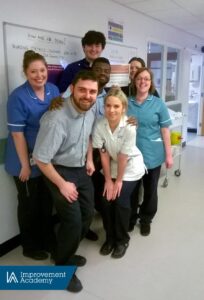 Photo of ward team with a bronze safety huddles certificate from the Improvement Academy